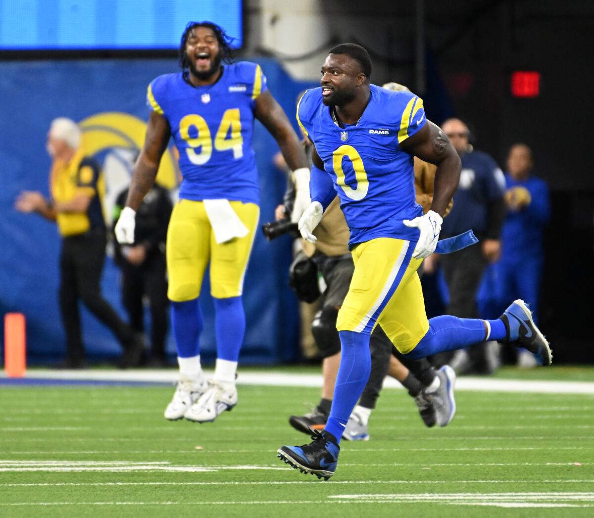 Rams players Dejuan Johnson (94) and Byron Young (0) celebrate a missed field-goal attempt by Seattle's Jason Myers.