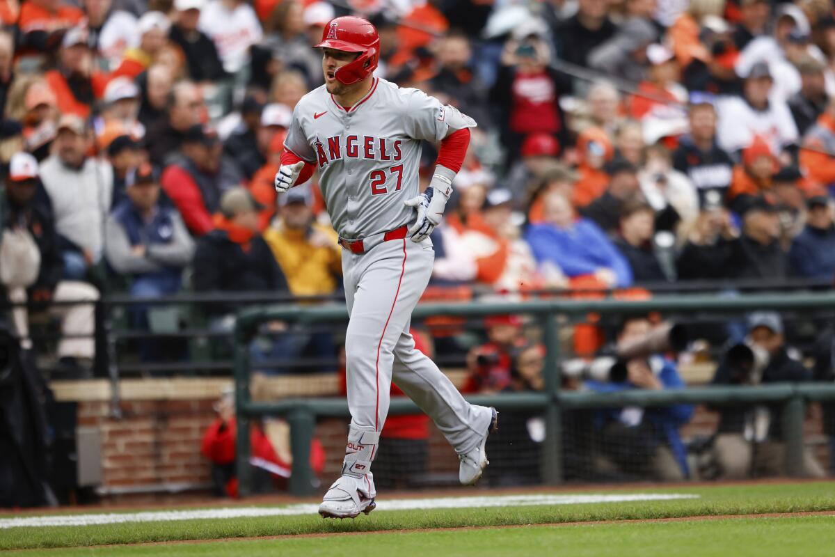 Angels star Mike Trout trots toward home plate after hitting a home run in the first inning.
