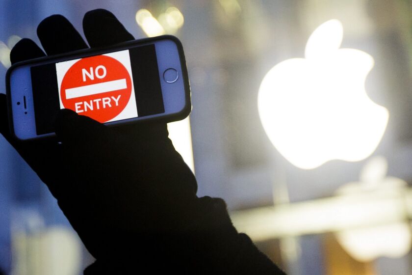A protester takes part of a February rally in front of an Apple Store in New York in support of the company's privacy policy.