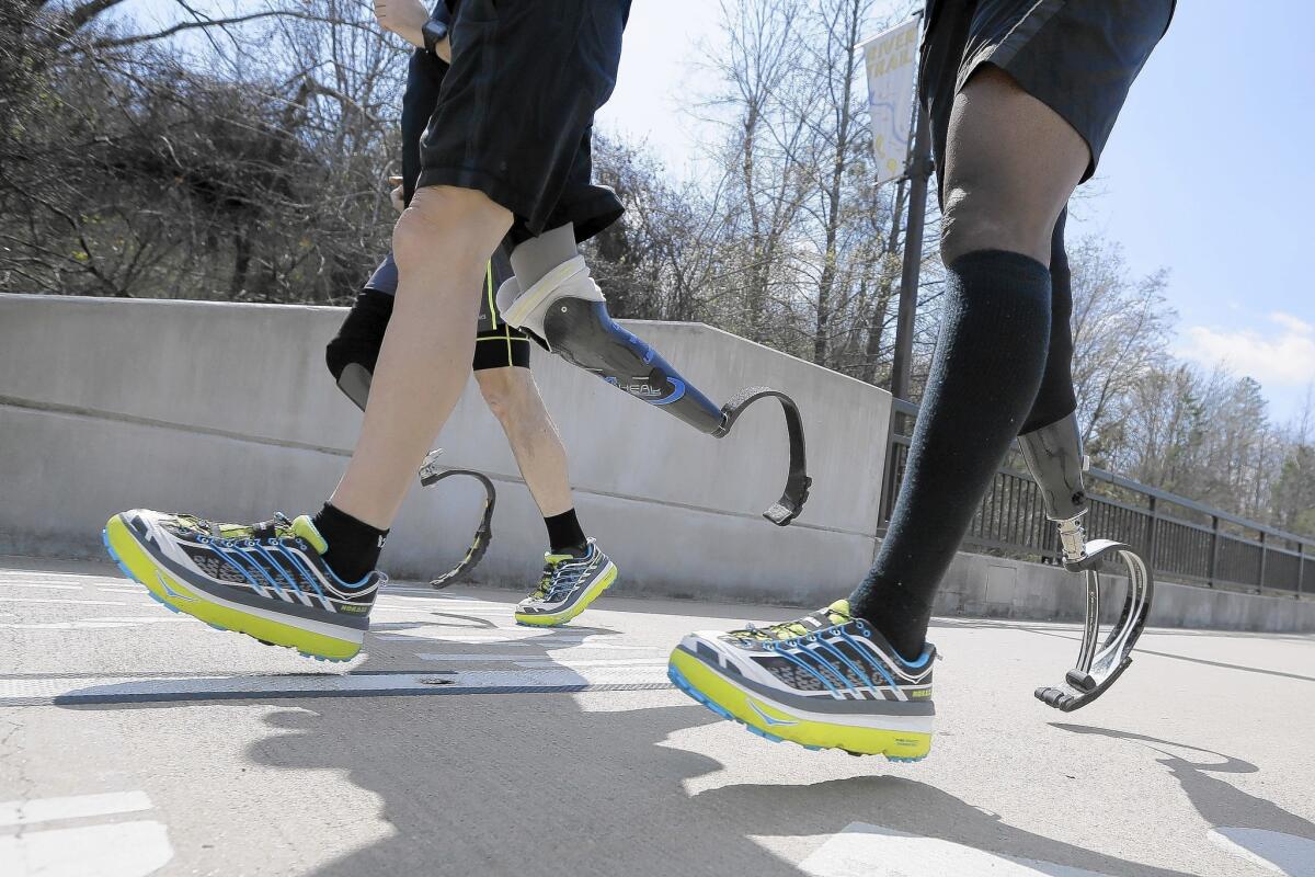 Three amputee marathon runners are seen training in Little Rock, Ark. Nearly 5,000 runners are taking the Boston Marathon up on its offer to return this year.