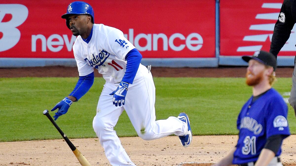 Dodgers shortstop Jimmy Rollins exits the batter's box as he watches his solo home run off Rockies pitcher Eddie Butler in the first inning Friday night.