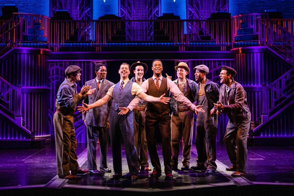 Eight men stand together on stage in 'Some Like It Hot" at the Shubert Theatre.