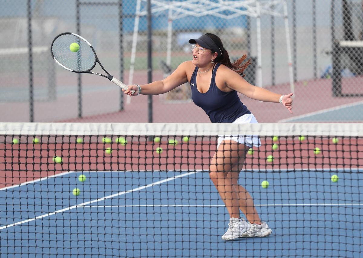 Fountain Valley girls' tennis player Melody Hom hits volleys during practice at Fountain Valley High on Tuesday.