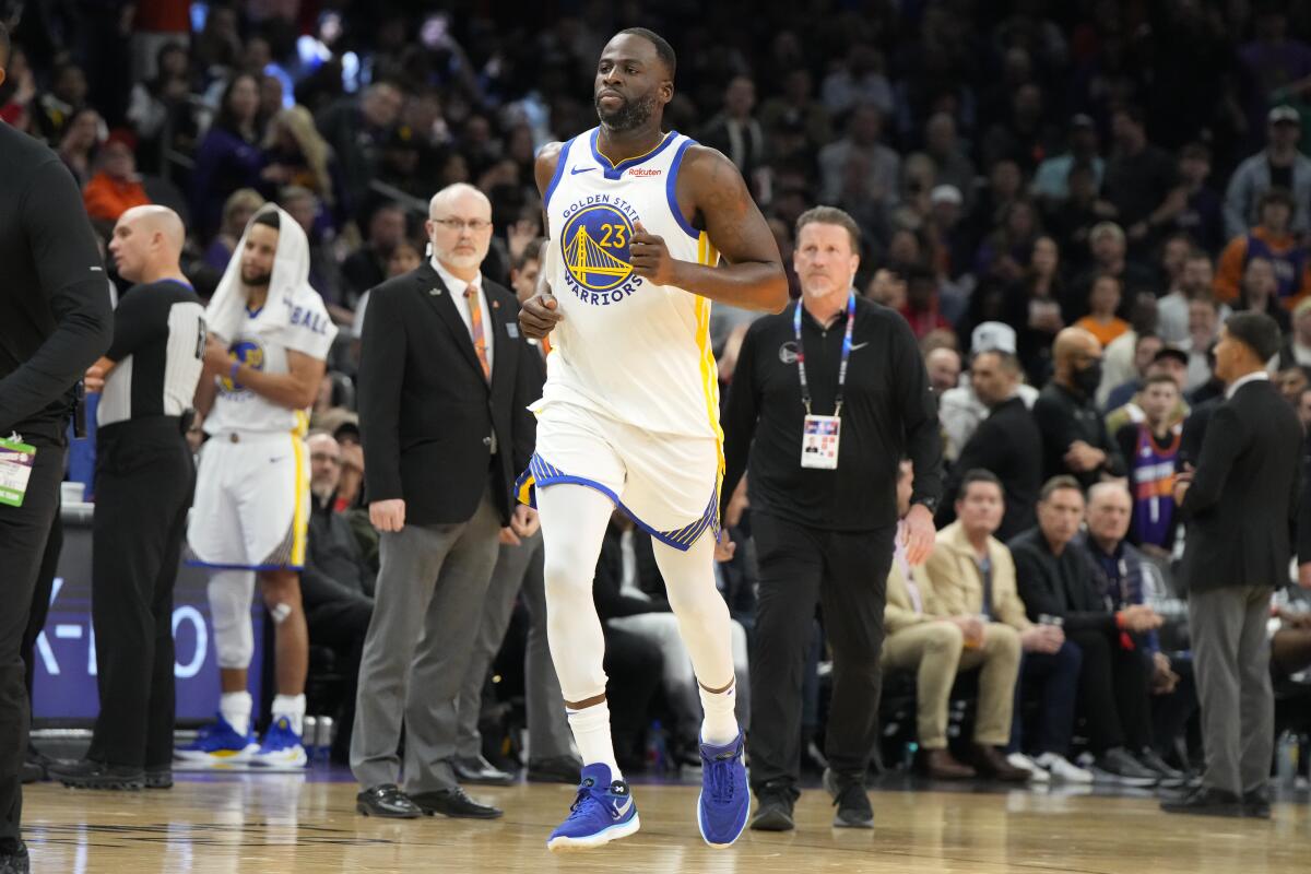 Warriors forward Draymond Green jogs off the court after getting ejected against the Suns.