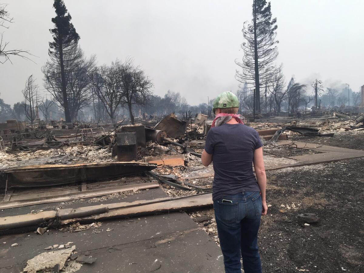 Sanaz Kiesbye surveys what's left of her home after the Tubbs fire in 2017. The blaze decimated the Coffey Park neighborhood in Santa Rosa.