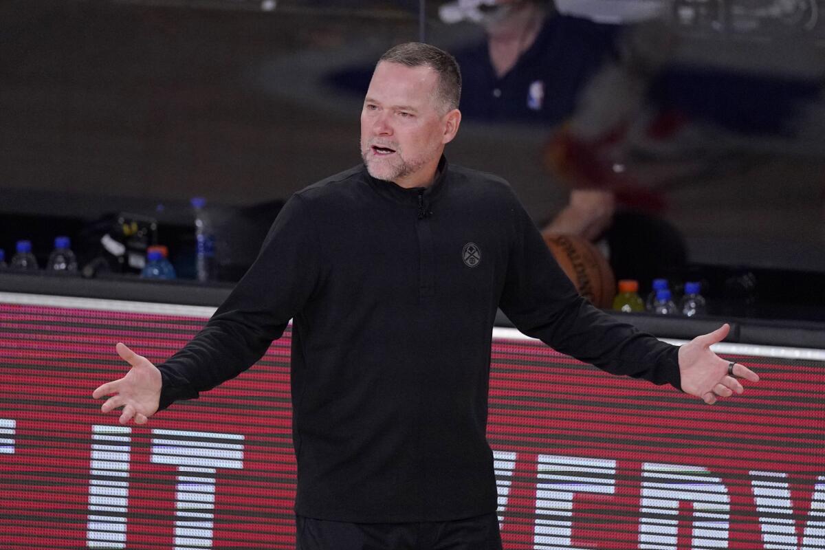 Nuggets coach Michael Malone questions a referee's call during Game 1 of the playoff series against the Clippers on Sept. 3.