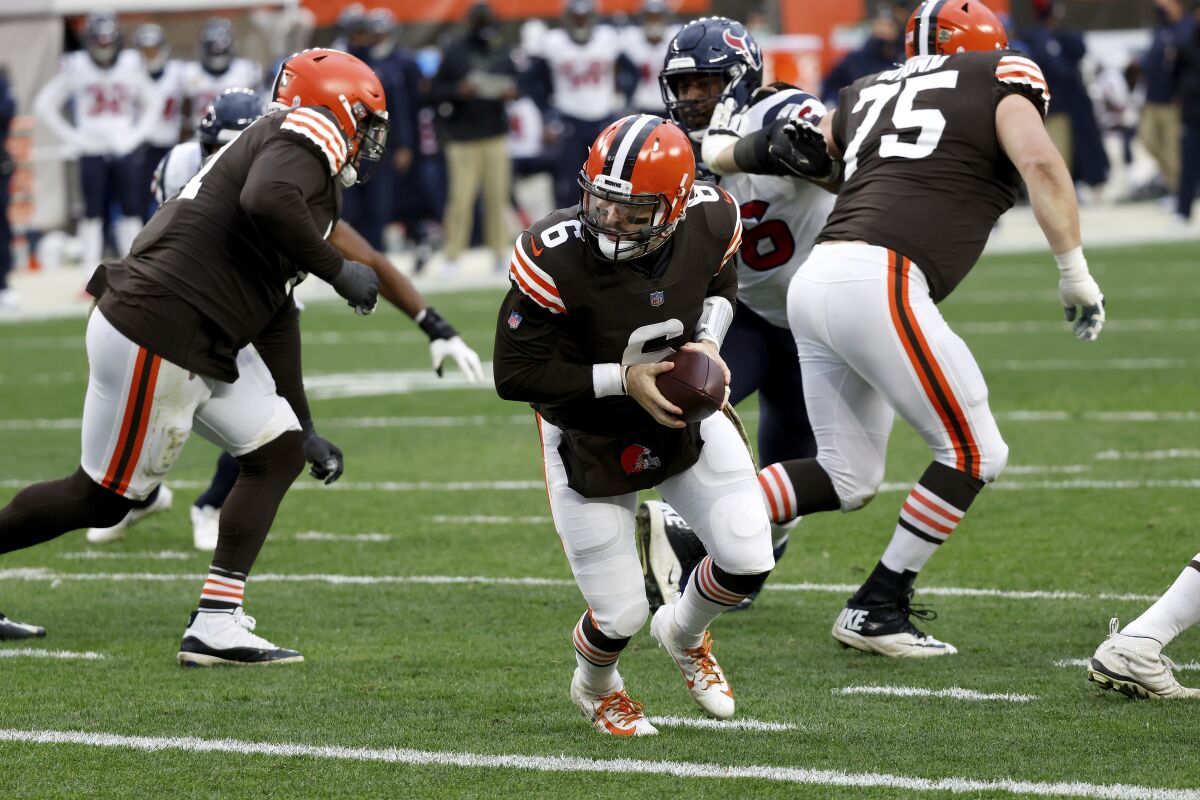 Cleveland Browns quarterback Baker Mayfield looks to hand off the ball during a game against the Houston Texans.