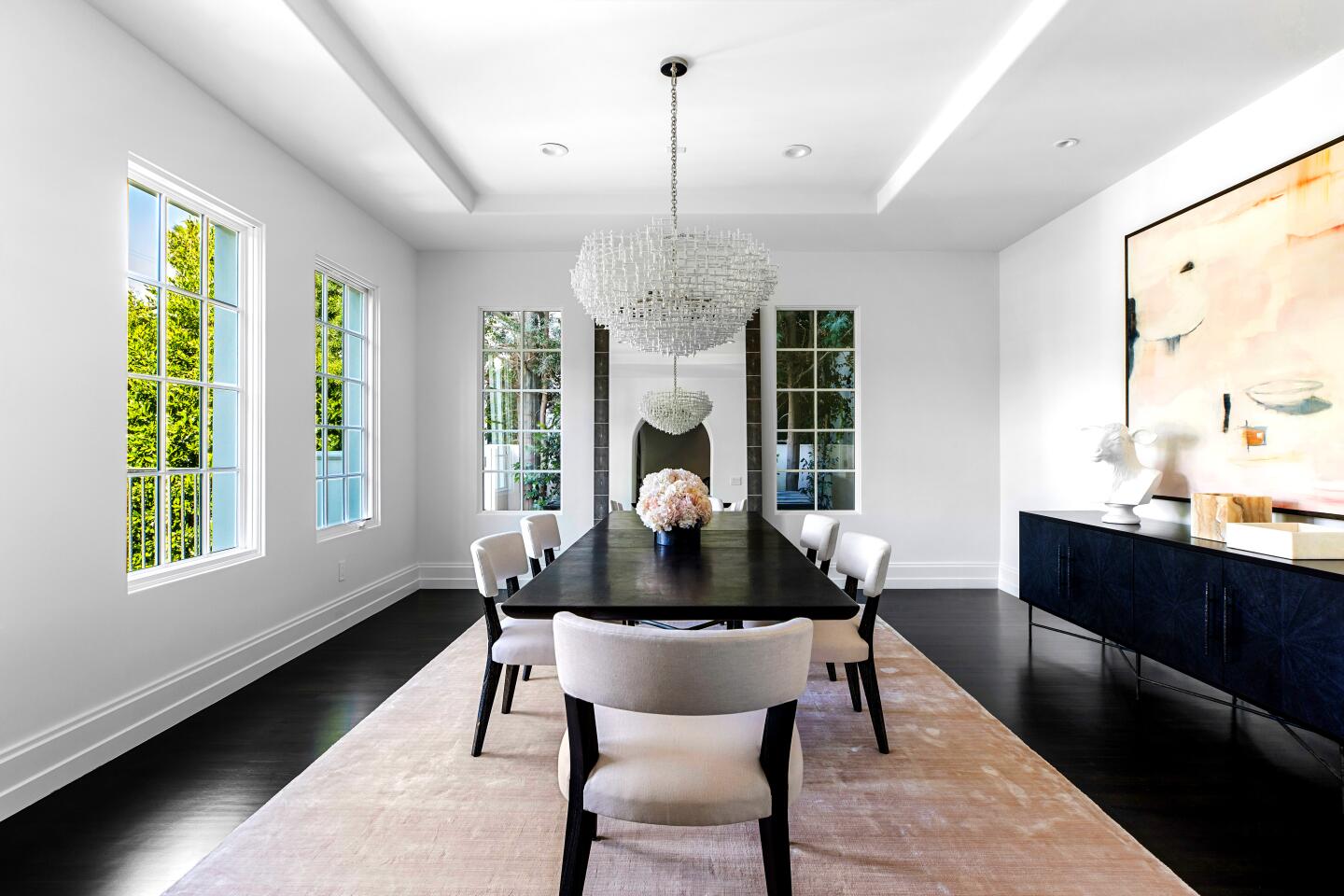 Polished to a fine sheen, the designer-done interiors feature dark wood floors that stand out against white walls.