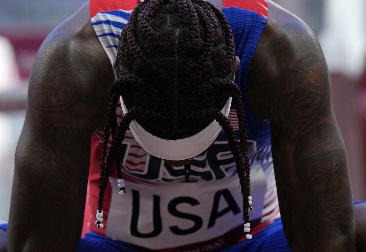 U.S. sprinter Cravon Gillespie has his head down in disappointment