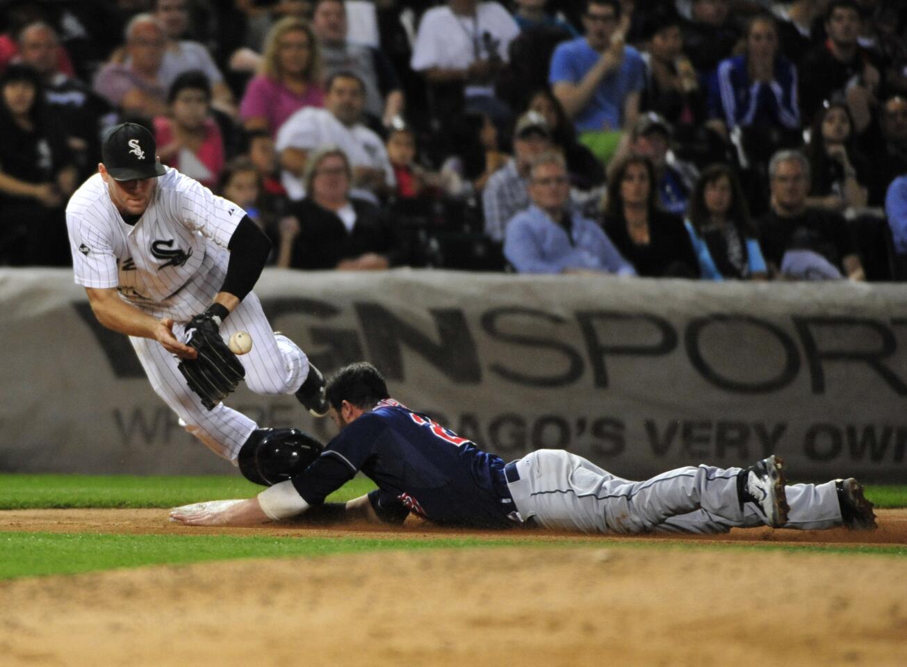 The Indians' Jason Kipnis is safe at third base as Conor Gillaspie takes the throw during the sixth inning.