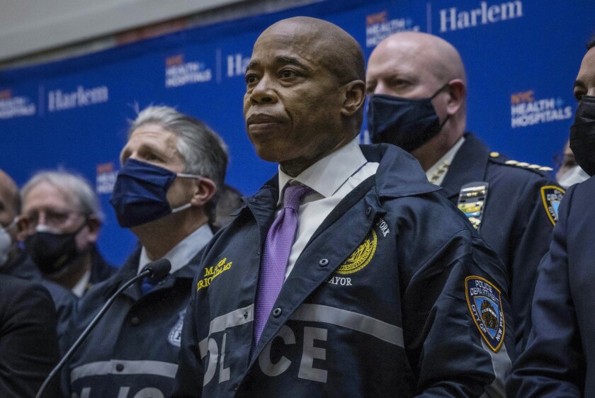 FILE - New York City Mayor Eric Adams, center, speaks during a news conference at a Harlem hospital after the shooting of two NYPD officers, Jan. 21, 2022, in New York. Adams apologized Friday, Feb. 4, 2022, after a 2019 video surfaced showing him using a racial slur for white people when talking about the New York Police Department. (AP Photo/Yuki Iwamura, File)
