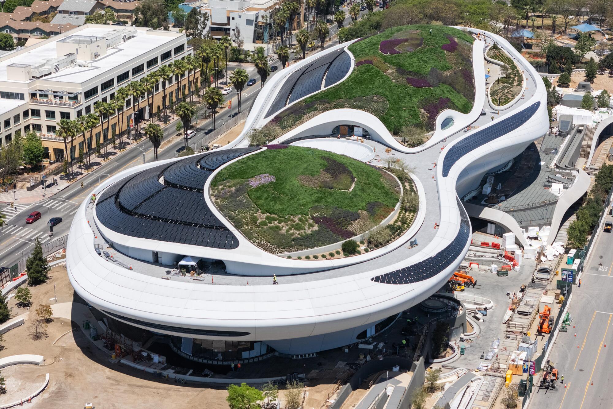 An aerial view of the spaceship-like Lucas Museum of Narrative Art under construction in Los Angeles.