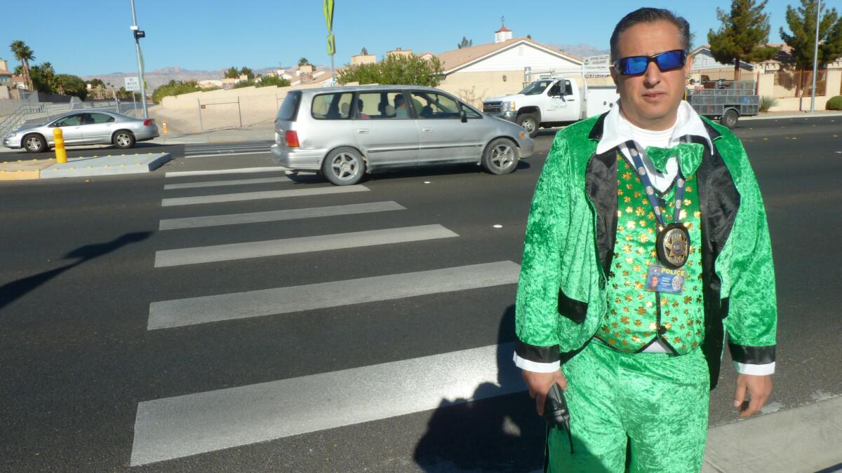 Clark County School District Det. Tom Rainey walks across the street in Las Vegas dressed as a leprechaun in a sting operation set up to see if drivers will stop for a pedestrian. Many don't.