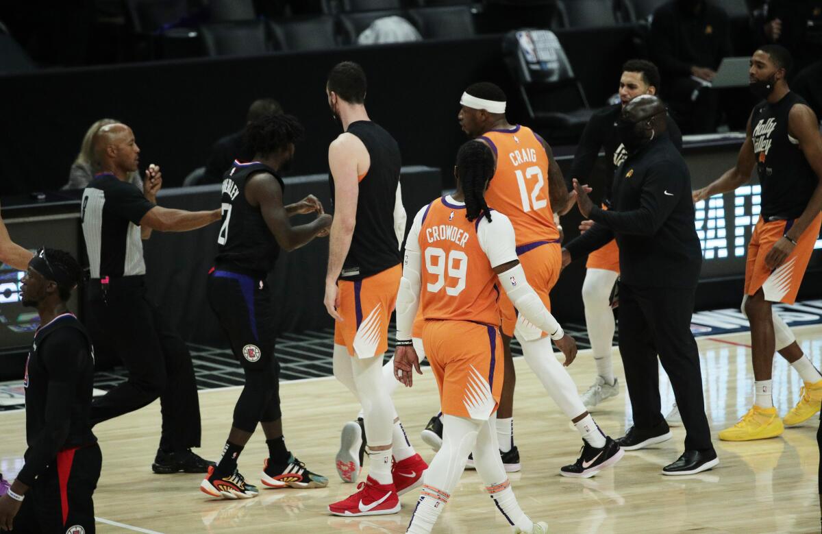 Clippers guard Patrick Beverley is surrounded by Suns players after he shoved Chris Paul in the back during Game 6.