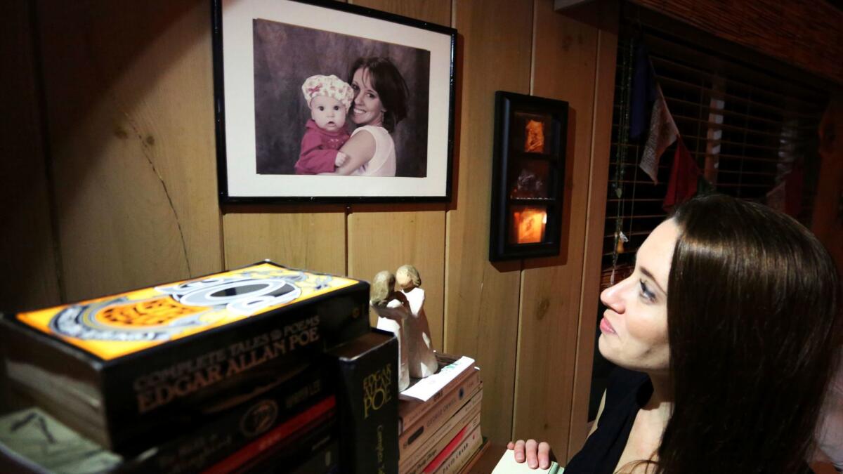 Casey Anthony looks up at a portrait of her with her daughter, Caylee, in her West Palm Beach, Fla., bedroom on Feb. 13, 2017.