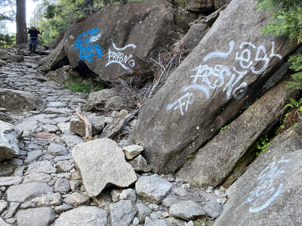 Graffiti in white and blue on boulders 