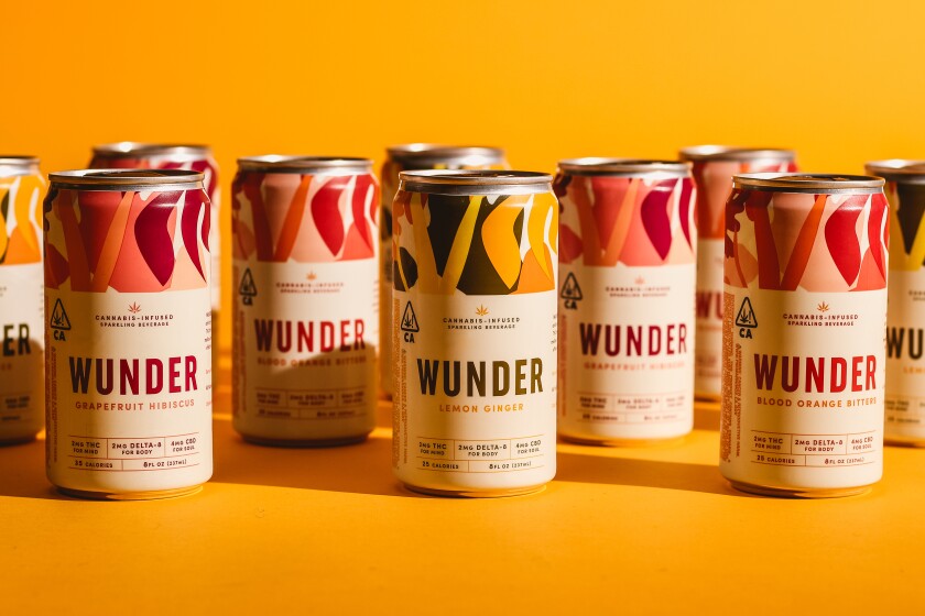 10 brightly colored beverage cans against an orange background.