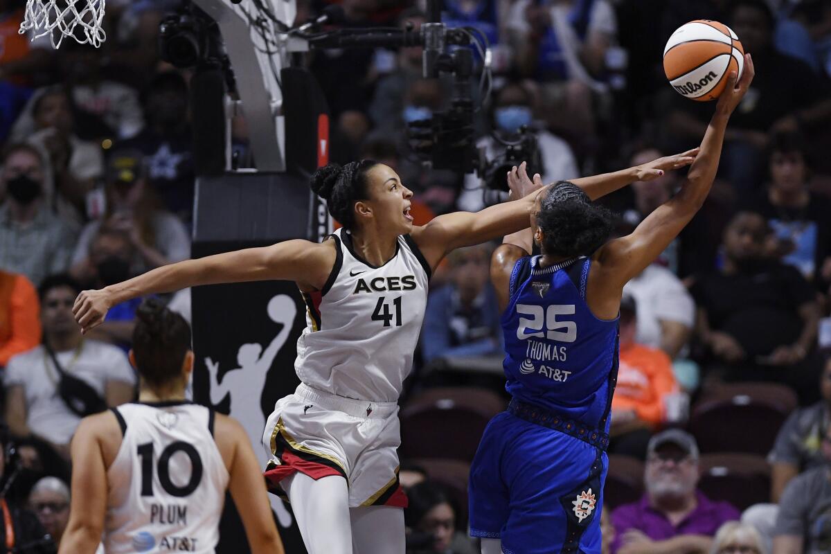 Connecticut Sun's Alyssa Thomas shoots as Las Vegas Aces' Kiah Stokes (41) defends during the second half in Game 3 of basketball's WNBA Finals, Thursday, Sept. 15, 2022, in Uncasville, Conn. (AP Photo/Jessica Hill)