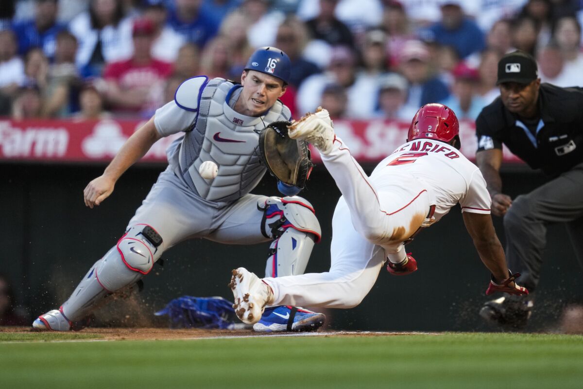 Angels' Luis Rengifo is out at home with a tag by Dodgers catcher Will Smith.