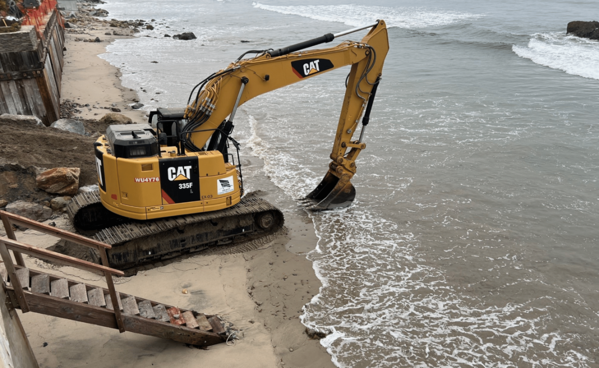 A photo of an excavator scooping sand in Broad Beach cited in the lawsuit.