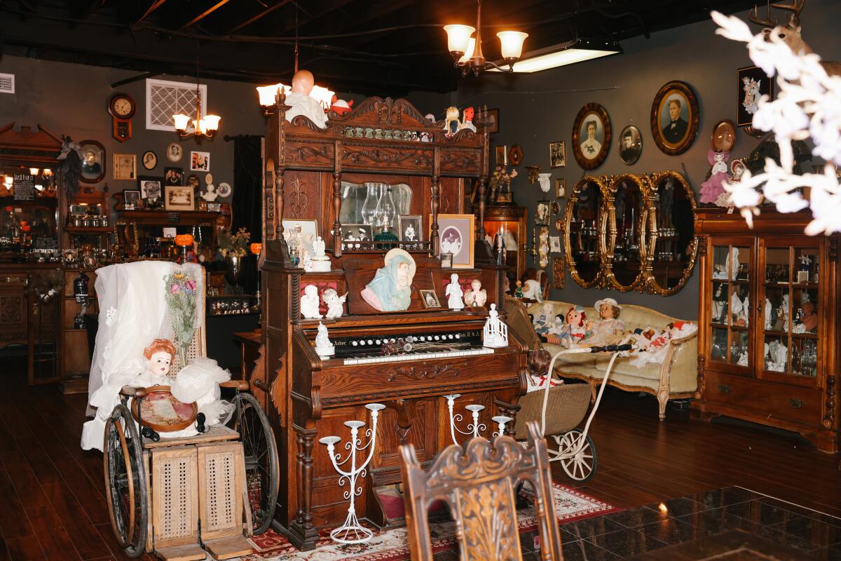 Ghoulish Delights' brick entry patio and doorway are decorated with skeletons.