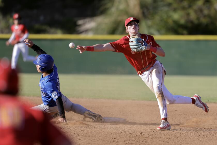 SAN DIEGO, CA - MARCH 28, 2024: After getting the force out on Rancho Bernardo's Nathan Bembenek, left, Cathedral Catholic's Alex Harrington throws to first base to turn a double play in the fourth inning of the Lions Tournament Open Division final at Cathedral Catholic High School in San Diego on Thursday, March 28, 2024. (Hayne Palmour IV / For The San Diego Union-Tribune)