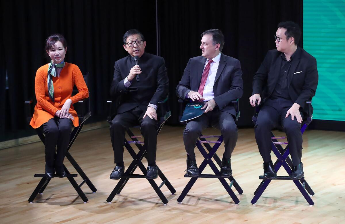 Pipa player Yu Liu, board member Charlie Zhang, Pacific Symphony President John Forsyte and concert violinist Dennis Kim.