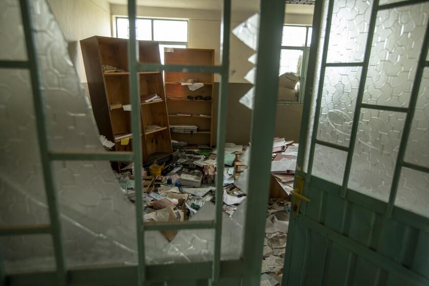 FILE - Medical equipment and files lie damaged and looted by Eritrean soldiers at a hospital which they used as a base, according to witnesses, in Hawzen, in the Tigray region of northern Ethiopia, on May 7, 2021. Eritrean troops and forces from the Amhara region, who have been fighting on the side of Ethiopia's federal military in the Tigray conflict, have been looting property and carrying out mass detentions in Tigray in Nov. 2022, according to eyewitnesses and aid workers. (AP Photo/Ben Curtis, File)