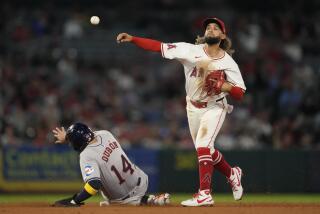 Los Angeles Angels shortstop Jack López (10) throws to first to complete a double play.