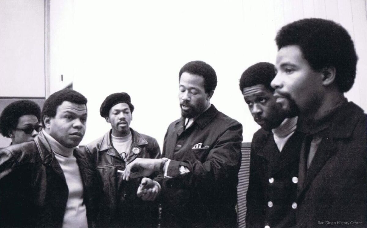Kenny Denmon, left, and Eldridge Cleaver, center, during Cleaver's visit to San Diego in 1968