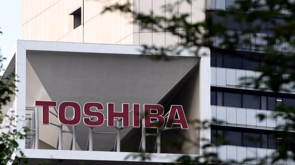 The Toshiba logo is seen on the top of a building at the company's headquarters in Tokyo on June 23.