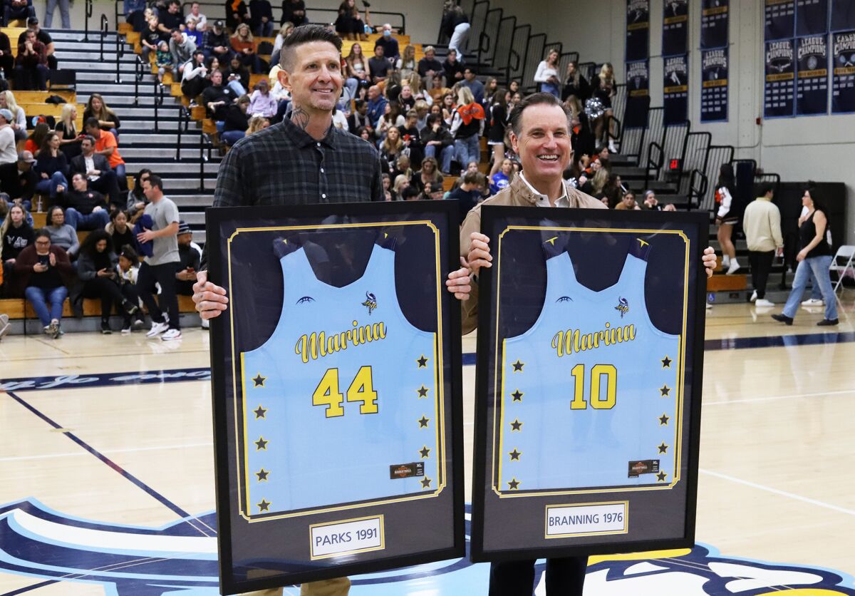 Cherokee Parks, left, and Rich Branning, both alumni of Marina High School, have their basketball jerseys retired.