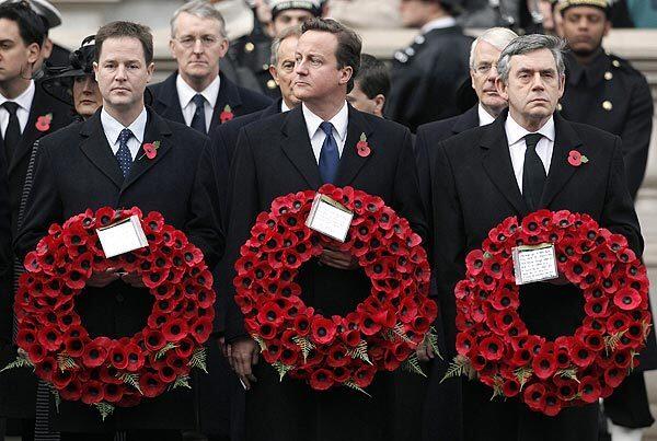 From left, Liberal Democratic leader Nick Clegg, Conservative chief David Cameron and British Prime Minister Gordon Brown hold poppy wreaths during the Remembrance Sunday service before the simple white marble Cenotaph, at Whitehall in London, paying tribute to the thousands of British and Commonwealth soldiers who died in world conflicts.