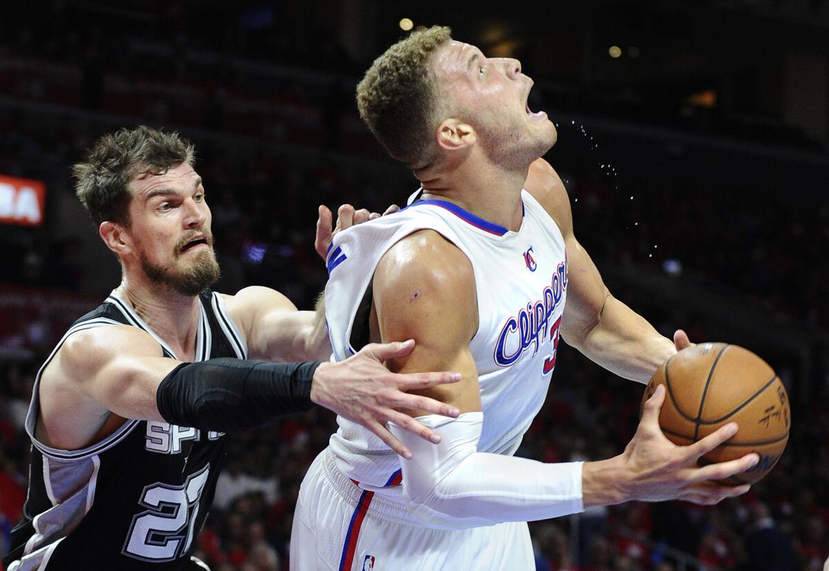 Clippers forward Blake Griffin is fouled by Spurs center Tiago Splitter in the first half of Game 1 on Sunday night at Staples Center.