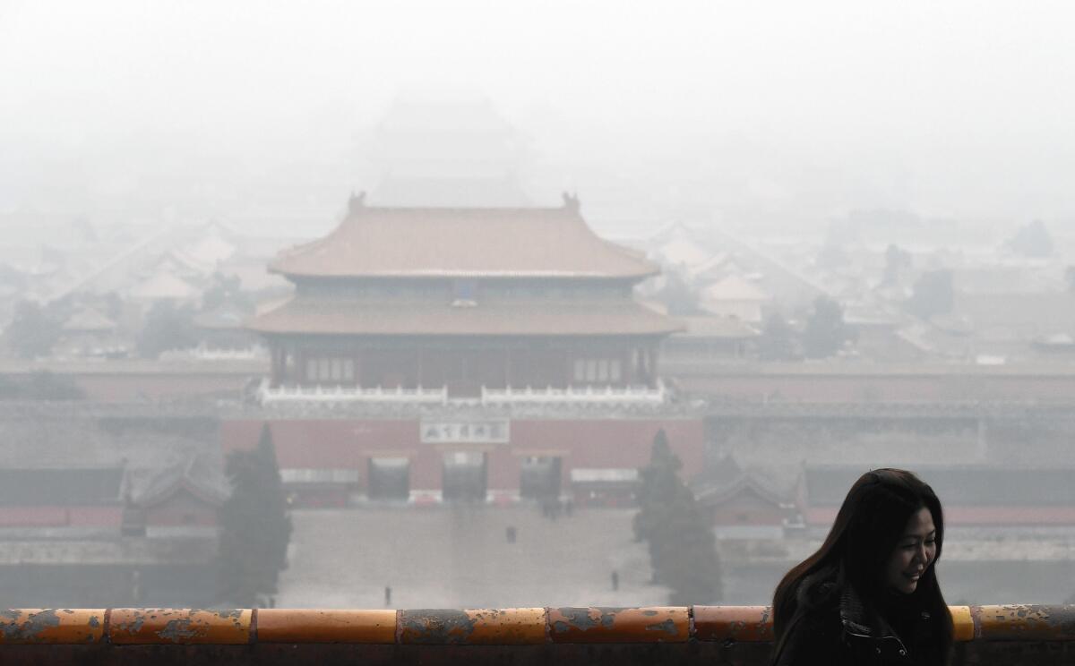Beijing’s Forbidden City is obscured by smog on Dec. 8. Dirty air in the capital is fueling a booming market for devices that measure indoor air quality, including the Laser Egg.