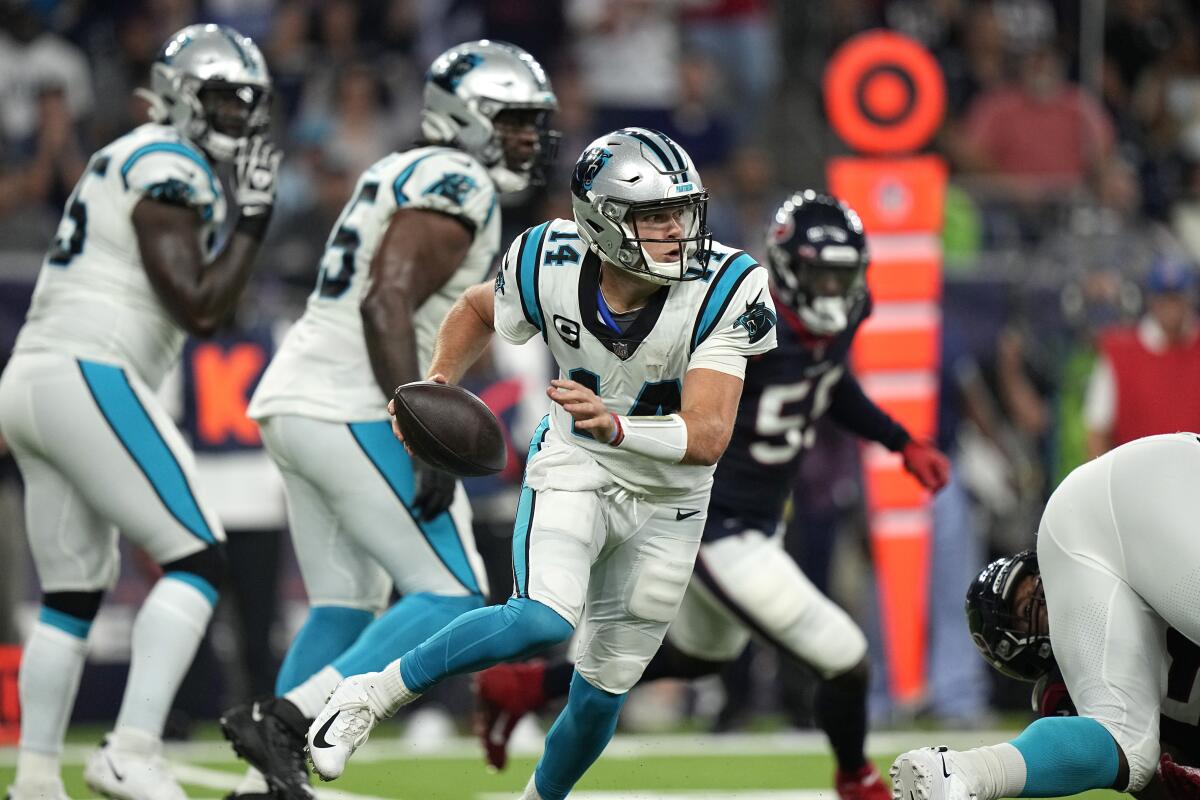 Carolina Panthers quarterback Sam Darnold scrambles out of the pocket against the Houston Texans.