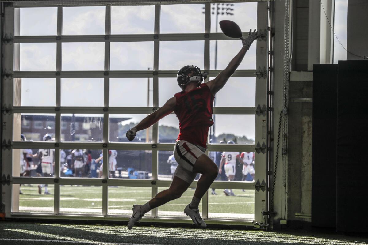 Tight end Chris Barrett makes a catch as the Liberty University football team practices at its indoor practice facility.