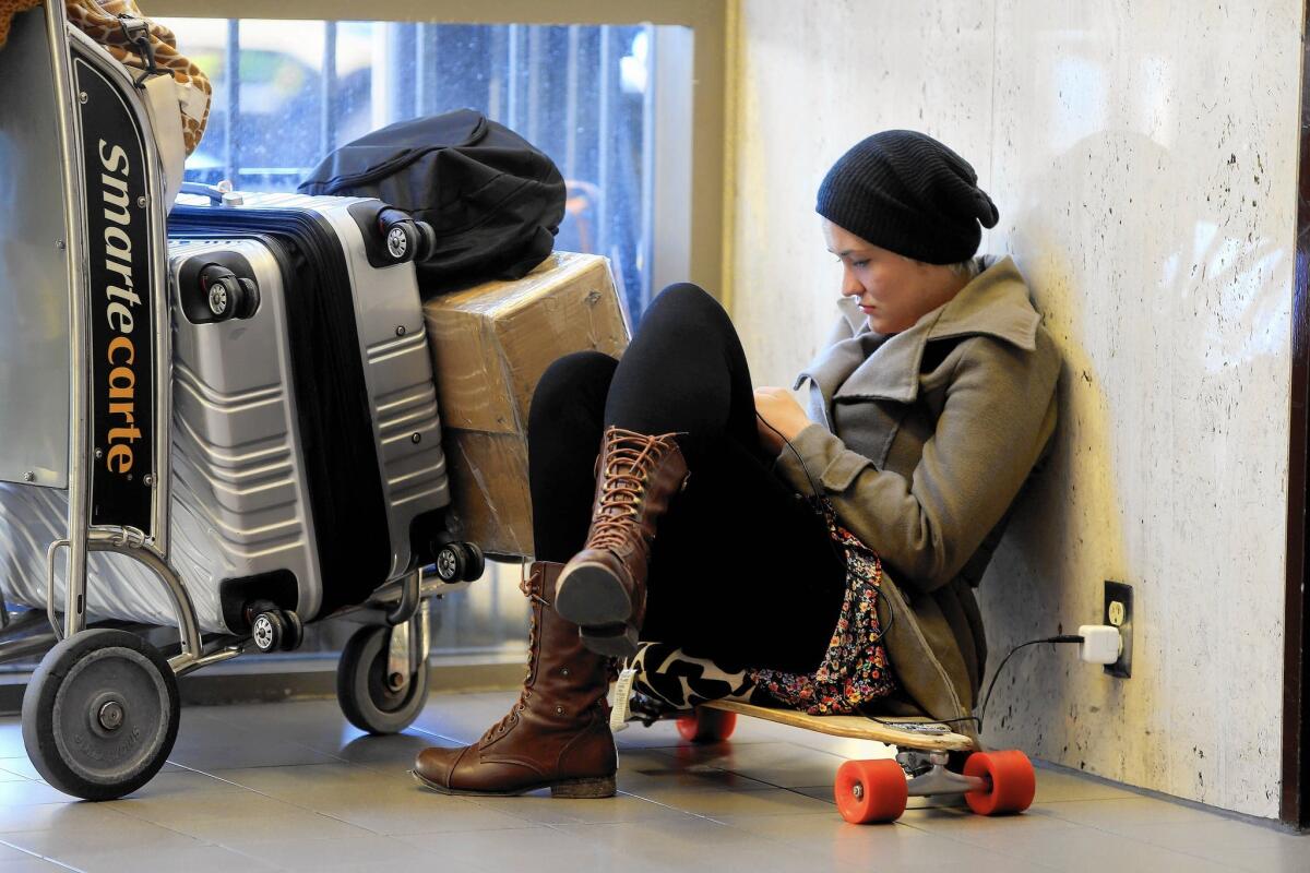 Taiana Milward of Brazil, who missed her flight, waits at Los Angeles International Airport.