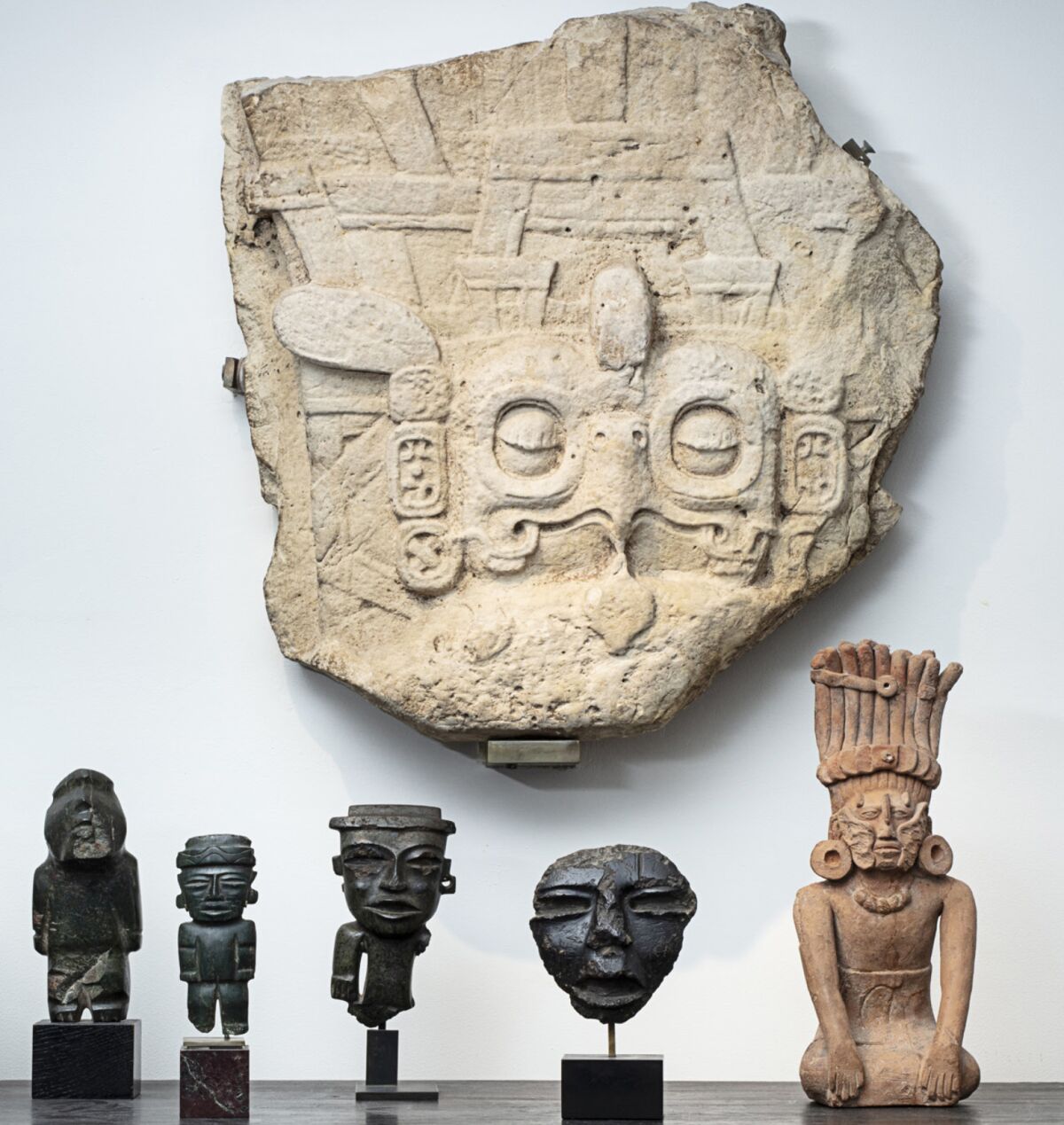 The large carved relief showing a Maya king's headdress with an owl motif is among works to be sold at auction in Paris.