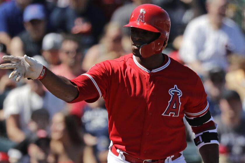 Los Angeles Angels' Justin Upton tosses aside his bat after walking against the Chicago White Sox in a spring training baseball game Friday, March 22, 2019, in Tempe, Ariz. (AP Photo/Elaine Thompson)