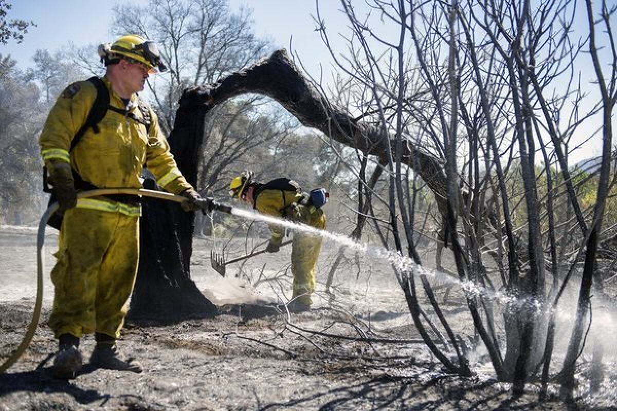 Firefighters complete containment on part of a fire in Twin Pines, Calif.