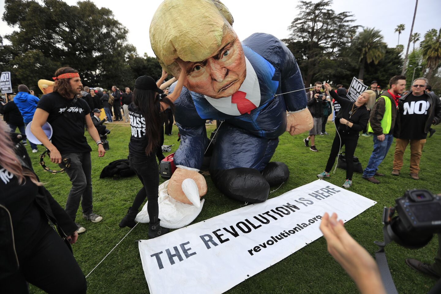 Protesters gather at the Beverly Gardens Park in Beverly Hills, as President Trump attended a local fundraiser.