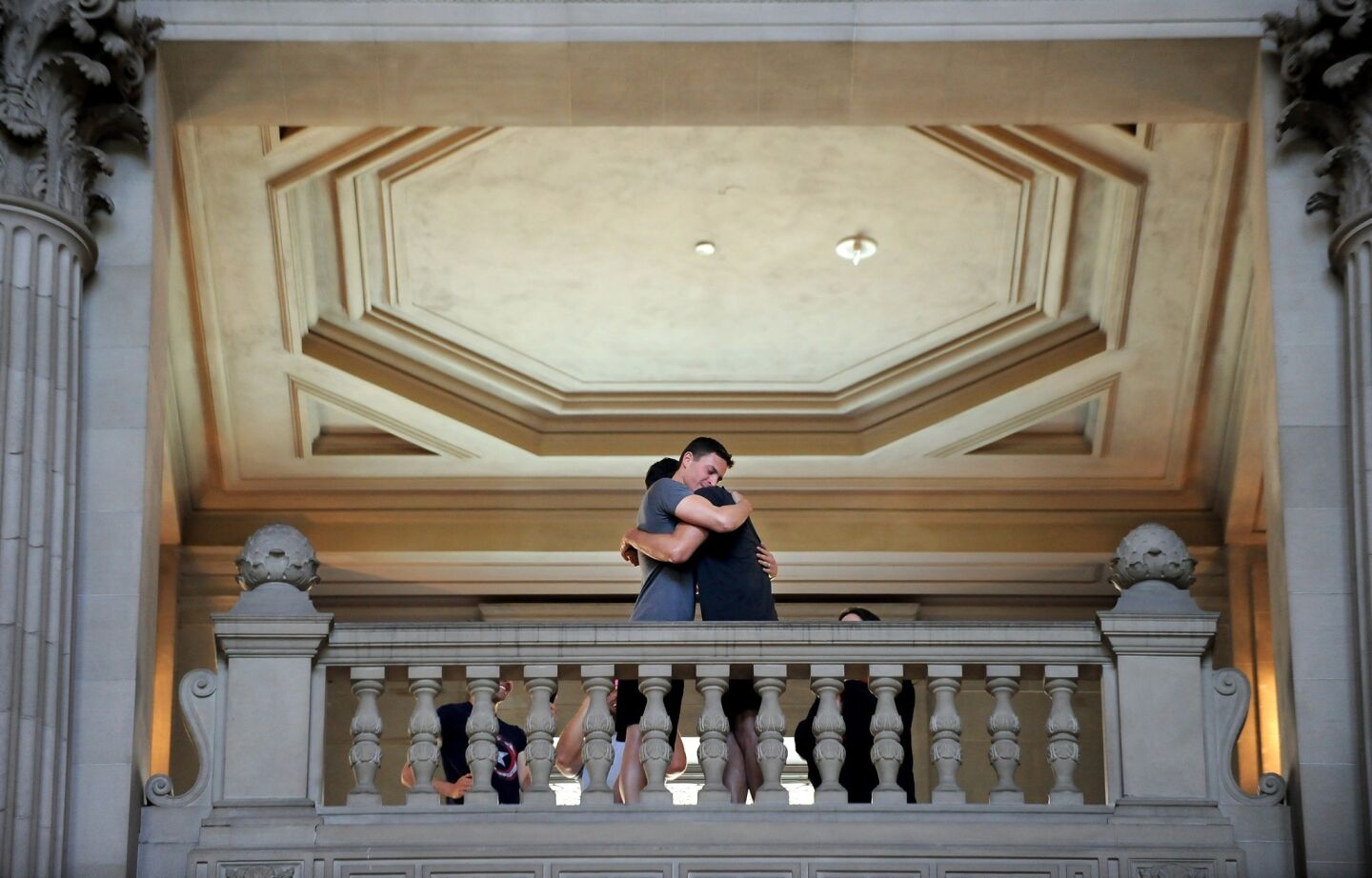 A couple hug during a marriage ceremony at City Hall in San Francisco Saturday.
