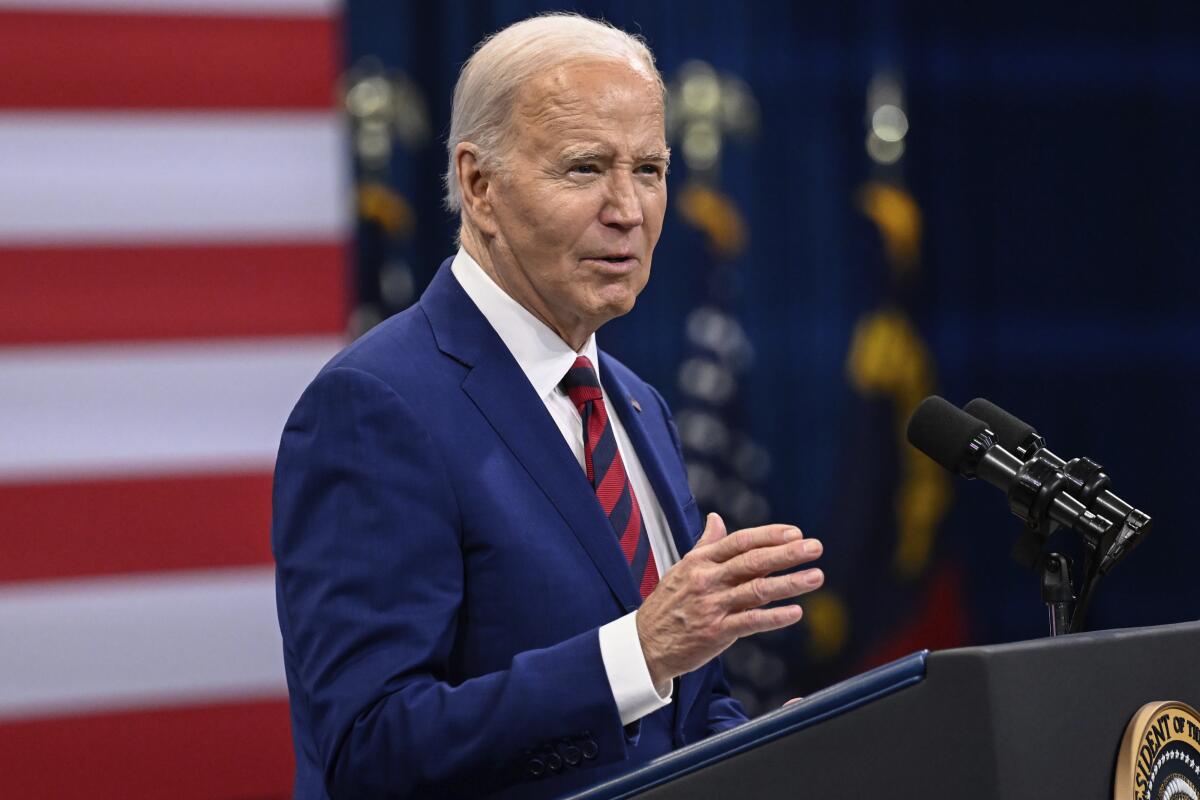 President Biden speaks at a dais at an event in North Carolina.
