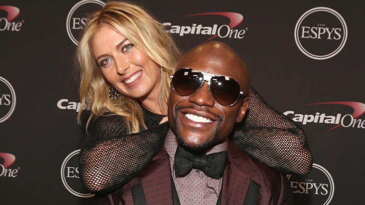 Tennis star Maria Sharapova poses with boxing star Floyd Mayweather Jr. backstage during the ESPYs at the Nokia Theatre on Wednesday.