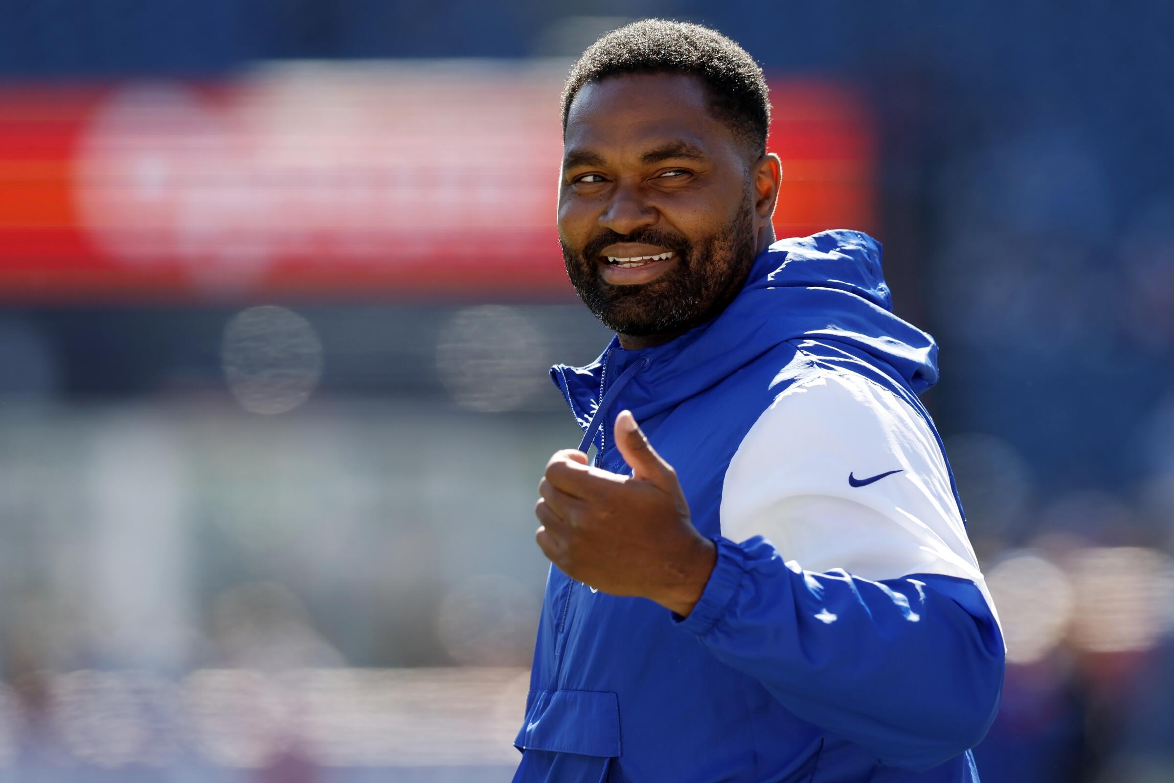 Patriots linebackers coach Jerod Mayo walks on the field before a game against the Lions.