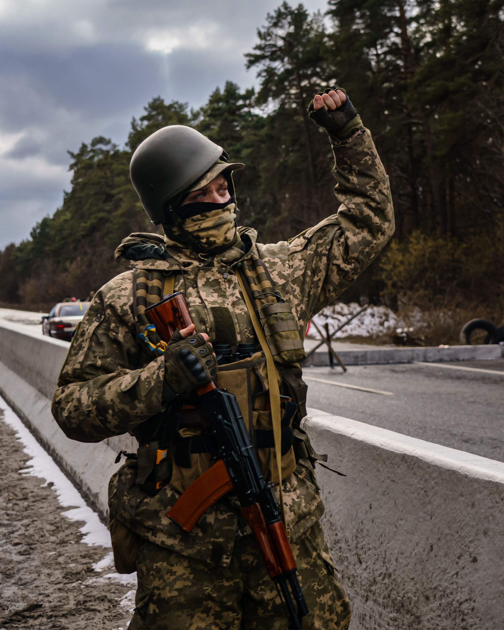 A Ukrainian soldier lowers his rifle, raises his fist in salute and chants 'Slava Ukraine.' 