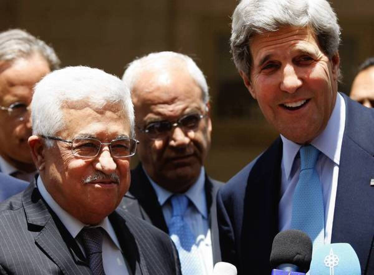 Palestinian Authority President Mahmoud Abbas, left, and U.S. Secretary of State John F. Kerry brief the media after meeting in the West Bank city of Ramallah. Kerry has made five trips to the region in the last three months.