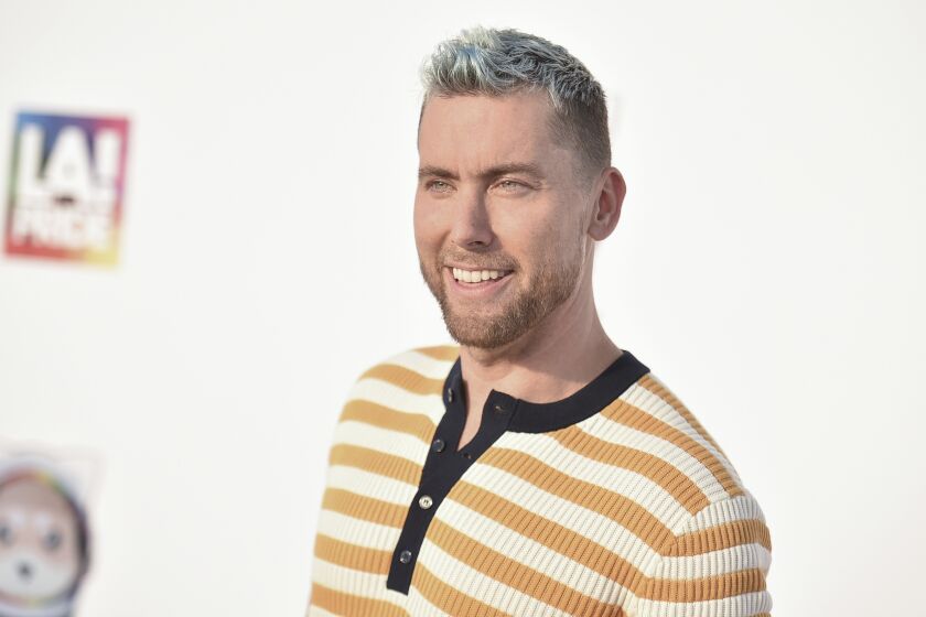 A blond man in a yellow and white striped shirt