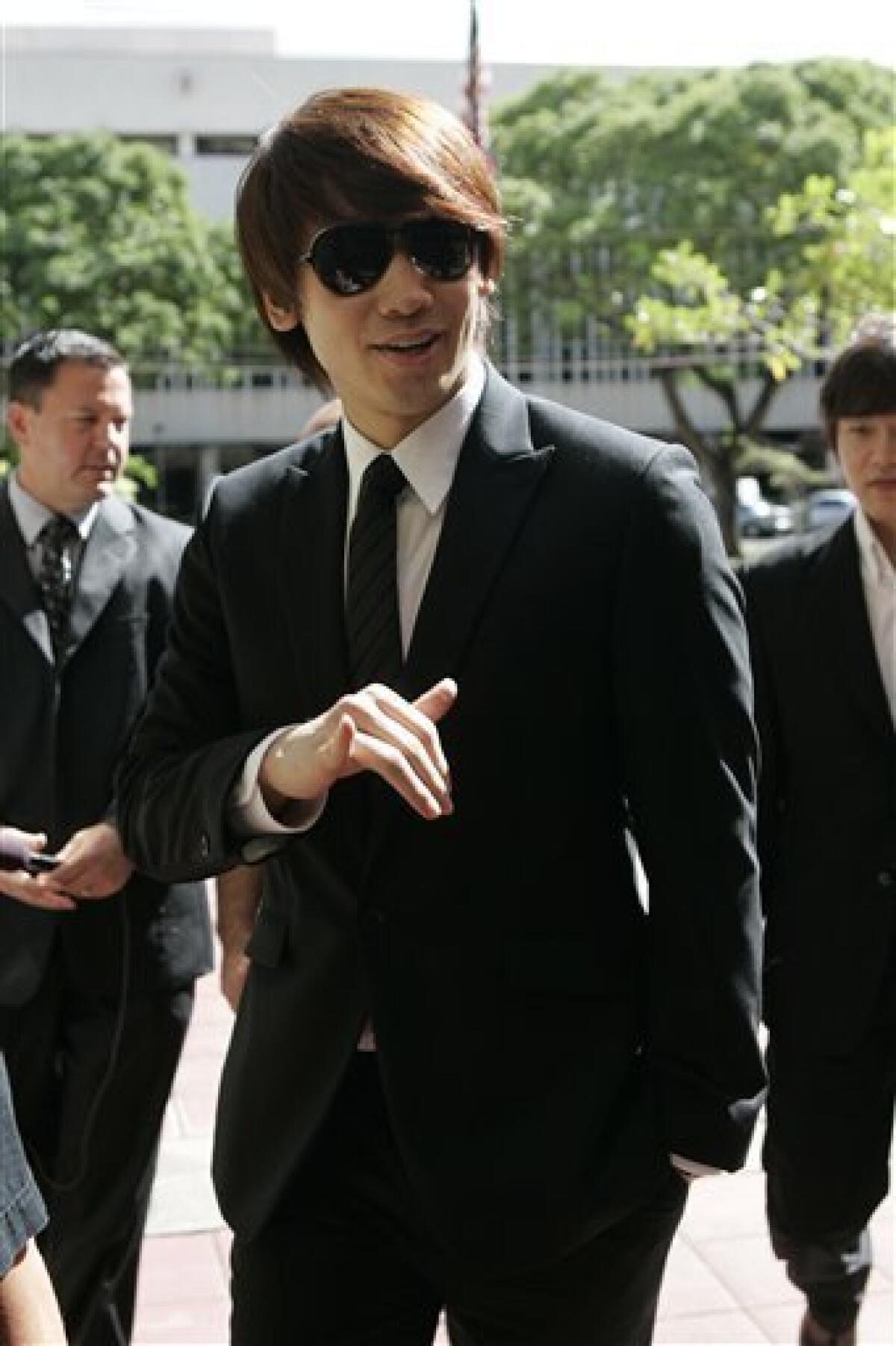 South Korean pop star and actor Rain, 26, flashes a Hawaiian "shaka" sign as he arrives at federal court, Monday, March 16, 2009, in Honolulu. Rain, whose real name is Jung Ji-hoon, and his producers are being sued over the performer's abrupt cancellation of a June 2007 concert in Honolulu. Rain is expected to testify. (AP Photo/Marco Garcia)